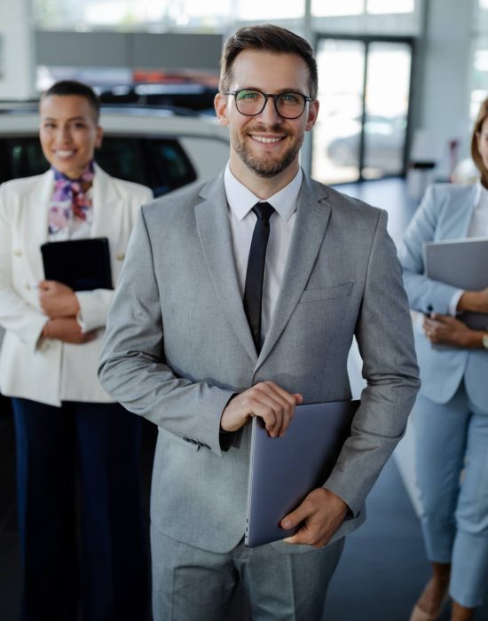 salesteam-in-dealership-three-beautiful-consultants-or-managers-in-elegant-suit-looking-on-camera-.jpg